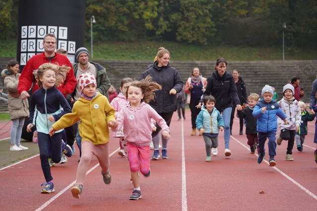 viele Kinder rennen auf rotem Boden