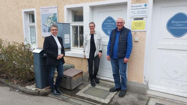 Drei Pesonen stehen vor dem Eingang des Rathauses