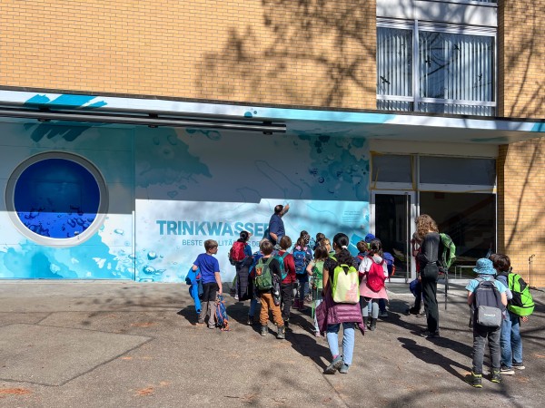 Eine Gruppe Kinder steht vor einem Gebäude.