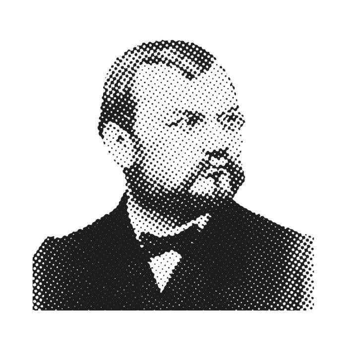 Schwarz-Weiß-Bild eines Mannes mit Brille, Bart und Anzug mit Fliege