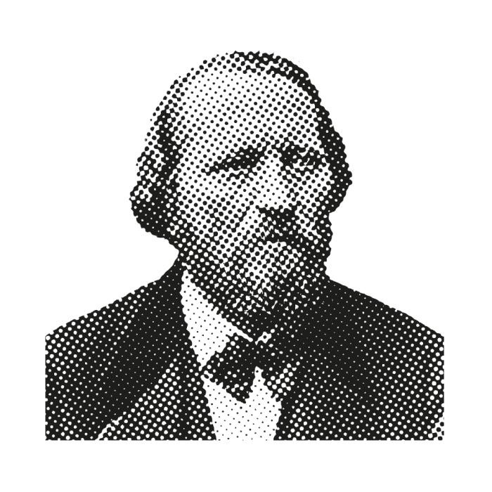 Schwarz-Weiß-Bild eines Mannes mit Bart, Anzugjacke und Fliege